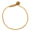 Gold-plated Peggy bracelet with irregular beads and adjustable brass clasp, elegant and timeless design.