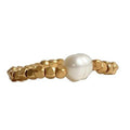 Peggy Stretch Ring featuring a white Pearl with gold-plated brass beads, handmade and elegant, unique jewelry design.