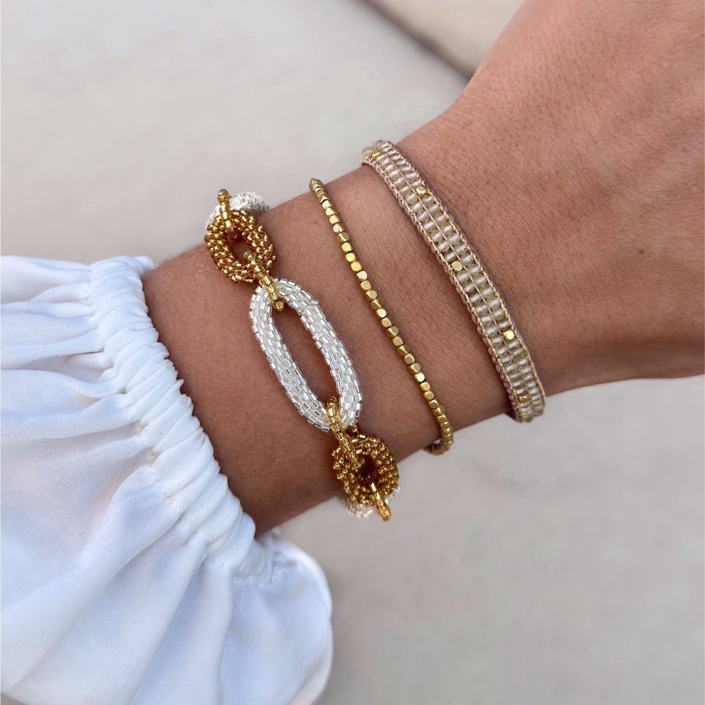 Gold-plated Peggy bracelet with irregular beads and adjustable brass clasp, elegant and timeless design.
