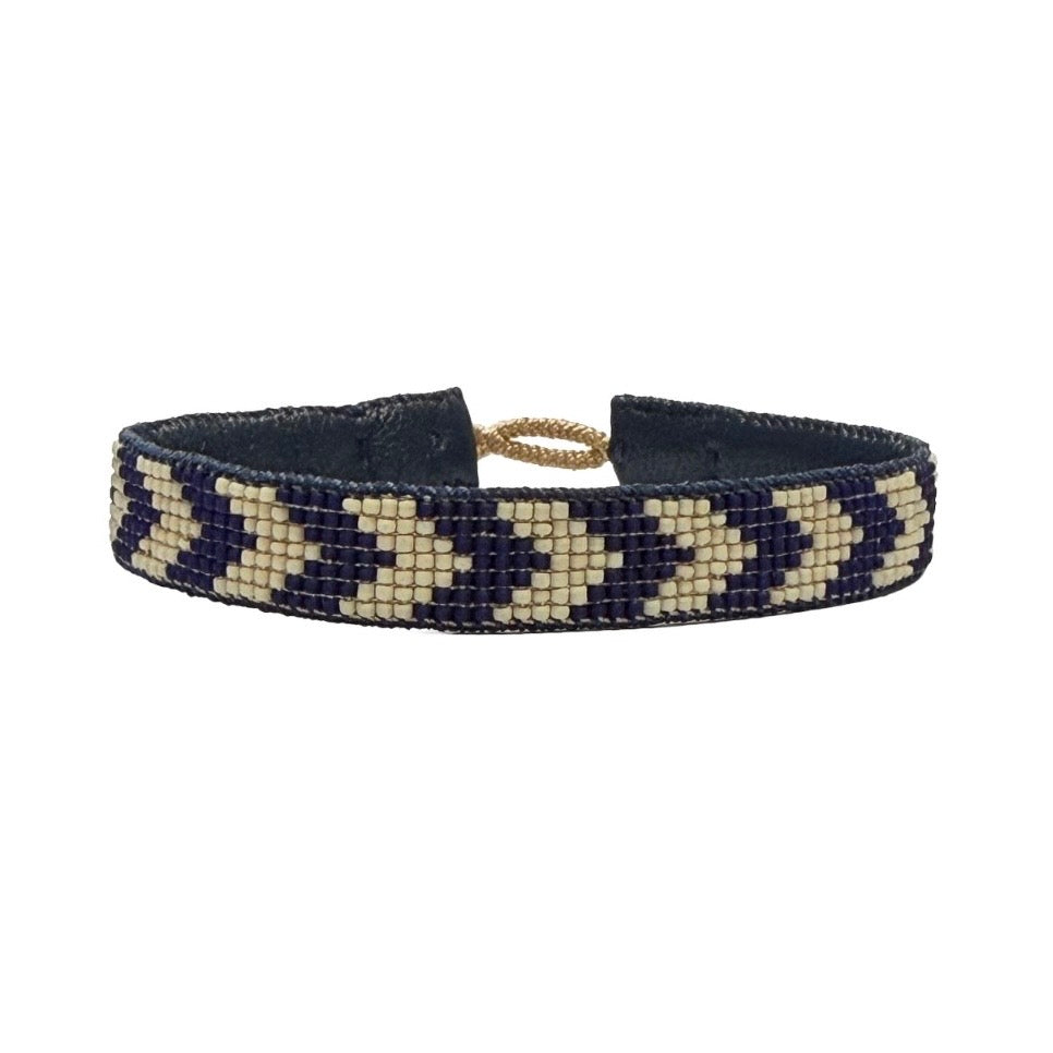 Handcrafted men's leather bracelet with Pool Blue/Bone arrow bead pattern and sterling silver closure.